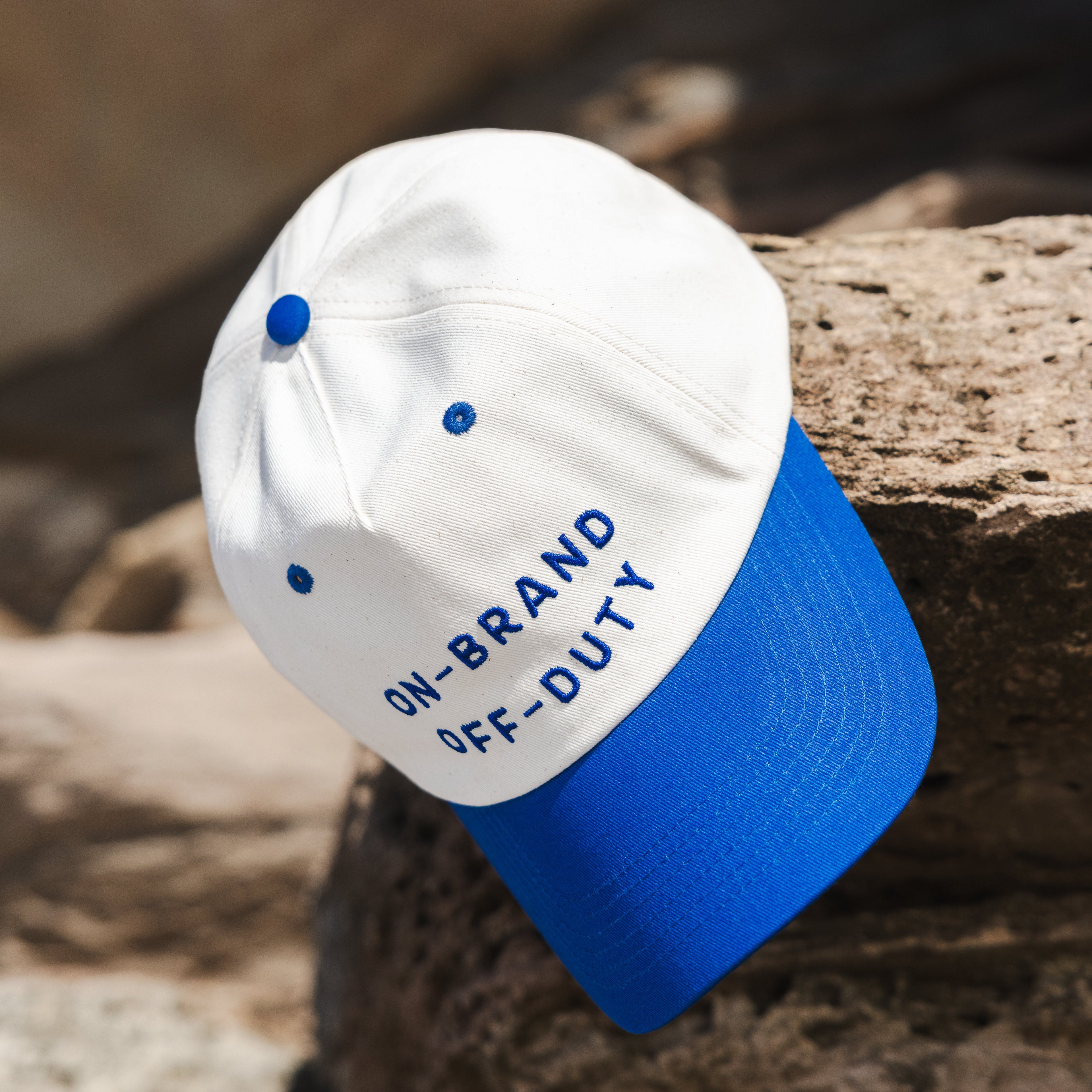 White and blue cap with text on a wooden surface