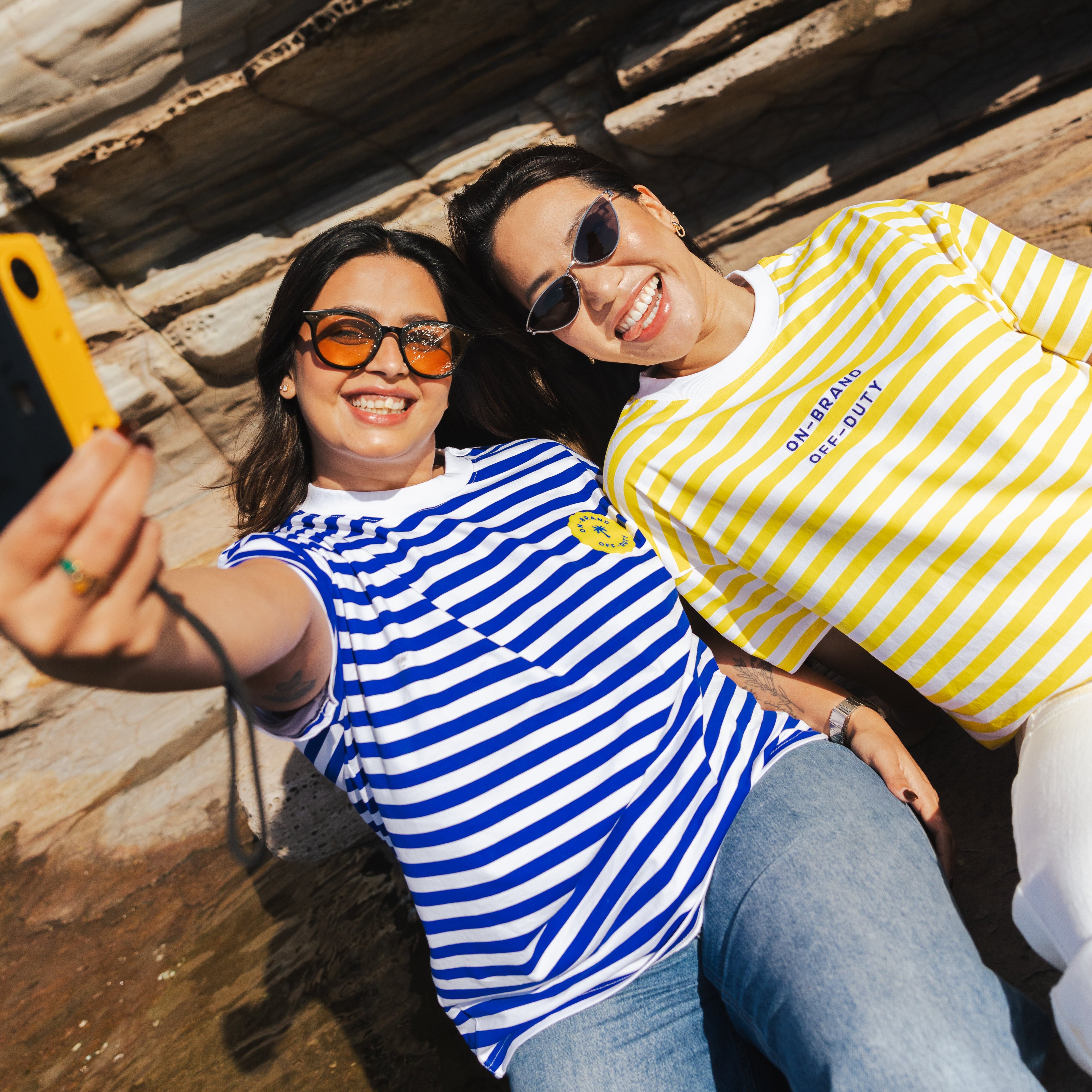 Two people taking a selfie against a rocky background